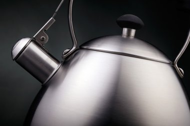 Tea kettle over dark background clipart