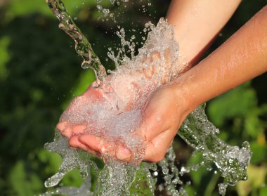 Woman's hands with water splash