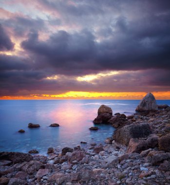 Sea stones at sunset clipart