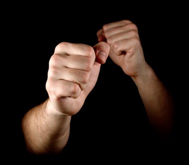 Two fists isolated on black background clipart