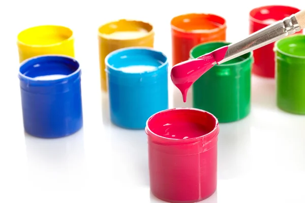Paint buckets with paintbrush over white background — Stock Photo, Image