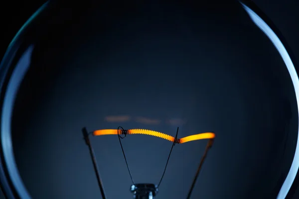 Glühbirne über dunklem Hintergrund — Stockfoto