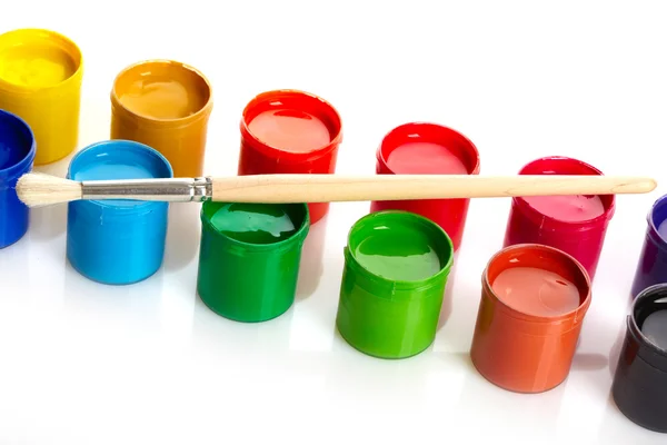 Paint buckets with paintbrush over white background — Stock Photo, Image