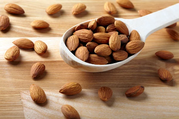 Almonds on wooden background — Stock Photo, Image