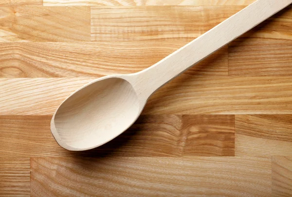 stock image Wooden spoon over wooden background