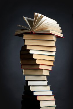 Pile of books on a black background clipart