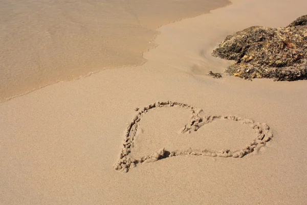 Corazón en la playa de arena —  Fotos de Stock