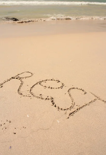 Palabra en la playa de arena — Foto de Stock