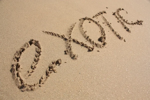 Woord op het zandstrand — Stockfoto