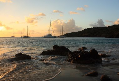 Caribbean sunset and sailboats clipart