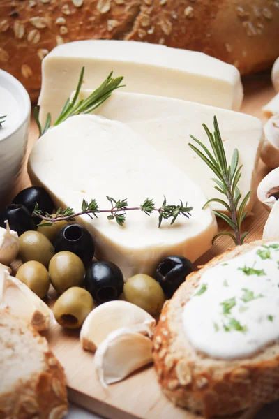 Cheese, herbs and olives — Stock Photo, Image