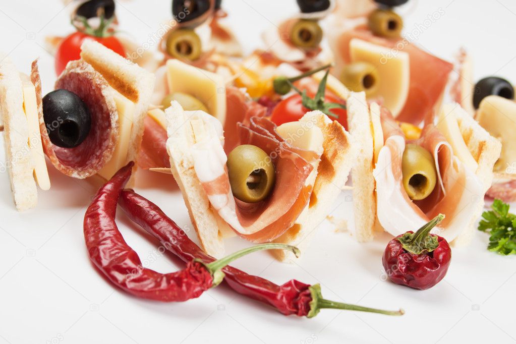 Canape with prosciutto and olives — Stock Photo © igordutina #10576298