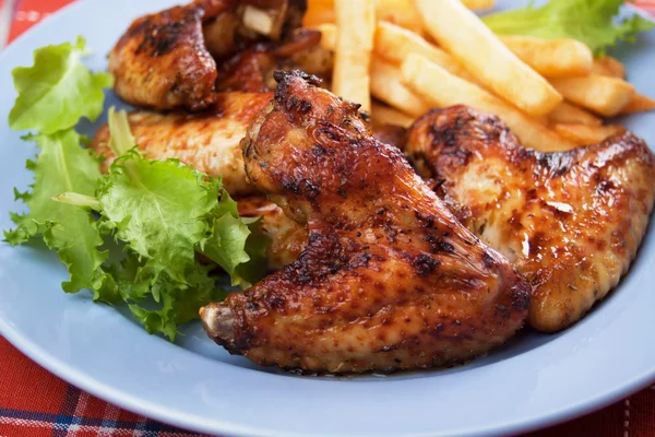 Grilled chicken wings with french fries — Stock Photo, Image