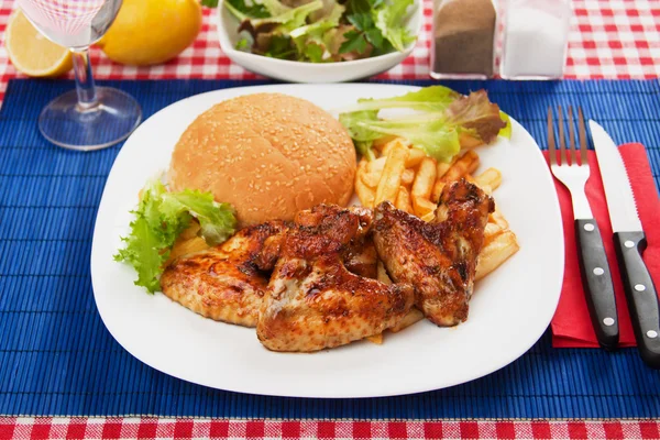 Grilled chicken wings with french fries — Stock Photo, Image