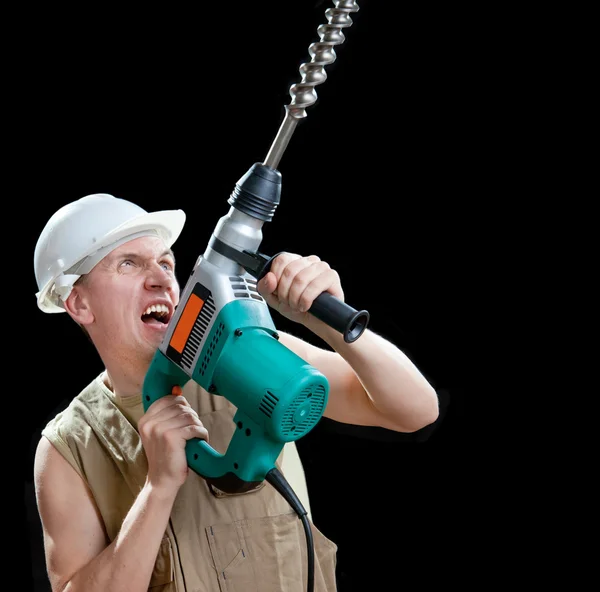Le constructeur dans un casque de protection tient le perforateur-marteau professionnel avec une perceuse de grand diamètre — Photo