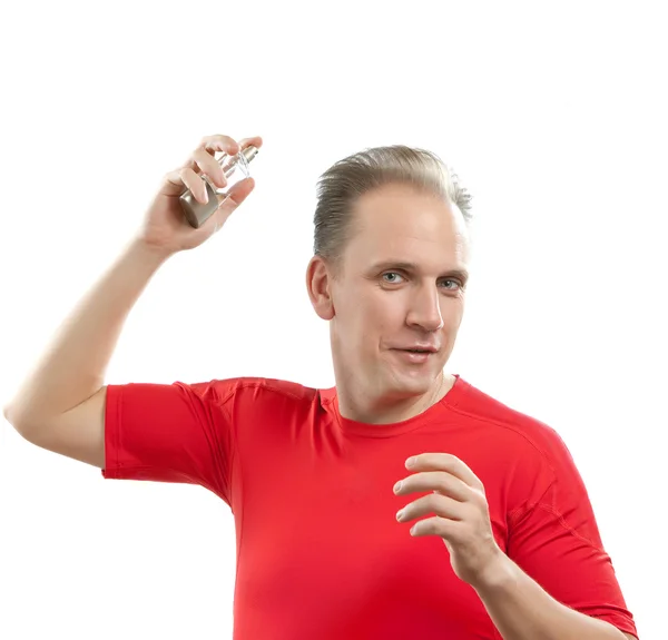 Sports man spraying fragrance perfume — Stock Photo, Image