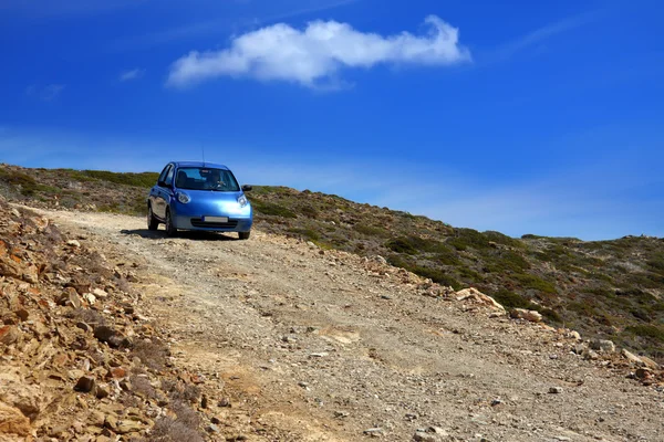 The car on a dirt road on a mountain slope. Greece. Rhodes — Stock Photo, Image