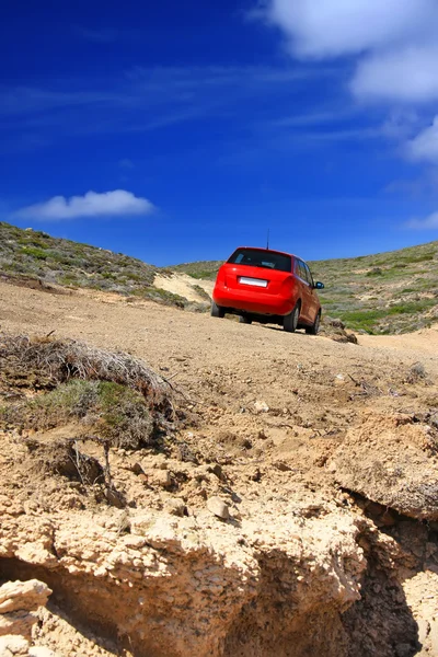 The car on a dirt road on a mountain slope. Greece. Rhodes — Stock Photo, Image