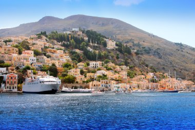 Boats and houses on symi island, Greece clipart