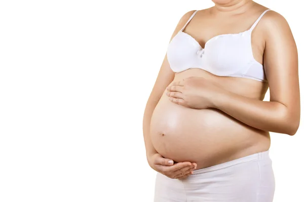 怀孕的女人照顾她的肚子里 免版税图库照片