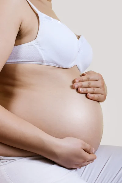 Pregnant woman take care about her belly — Stock Photo, Image