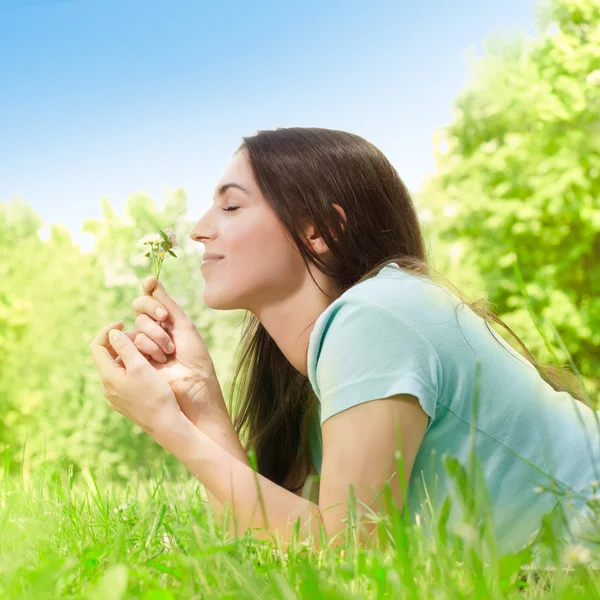 Beautiful young woman relaxing in the park at sunny spring day — Stock Photo, Image