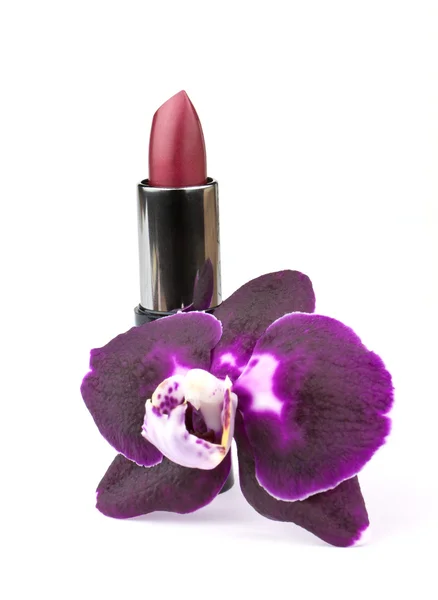 Orhid flower and lipstick — Stock Photo, Image