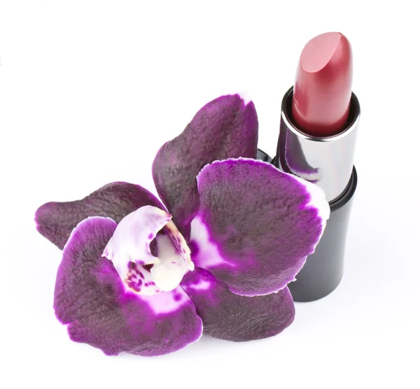 Orhid flower and lipstick — Stock Photo, Image