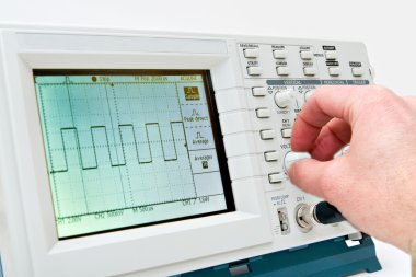 Engineer Operating a Digital Oscilloscope clipart