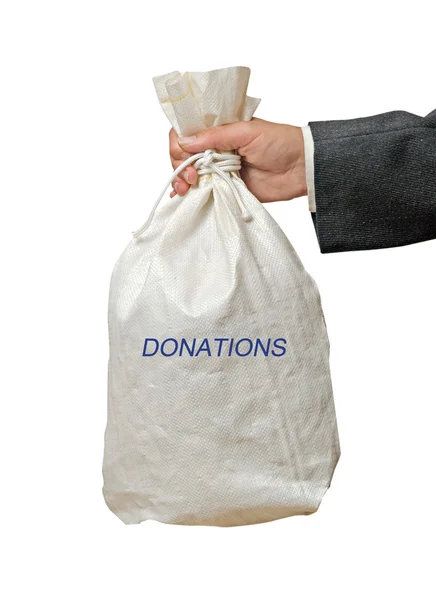 Bağış bir torba ile el — Stok fotoğraf