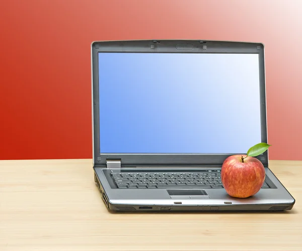 Notebook and apple on desk — Stock Photo, Image
