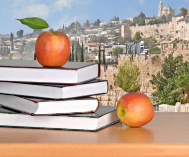 Red apple on open book clipart