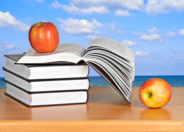 Red apple on open book — Stock Photo, Image