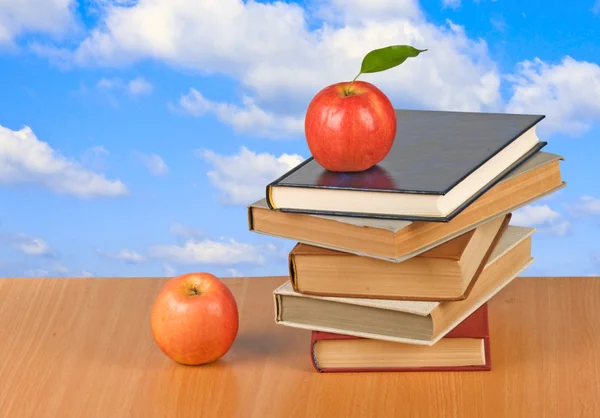 Manzana roja y libros en el escritorio — Foto de Stock