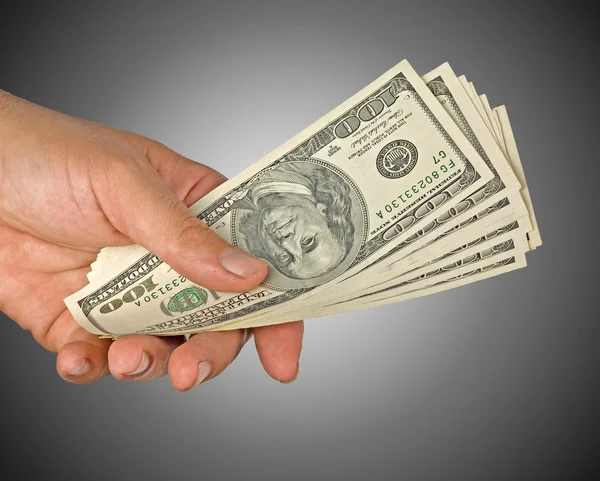 Hand mit Dollarscheinen isoliert im Hintergrund — Stockfoto