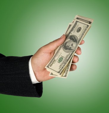 Hand with dollar bills isolated on background clipart