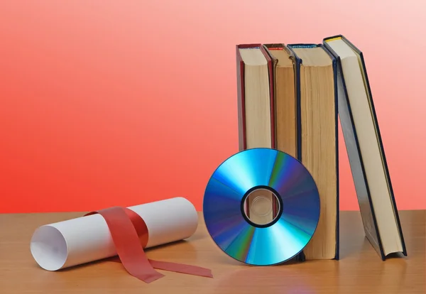 Desplázate con cinta roja y libros — Foto de Stock