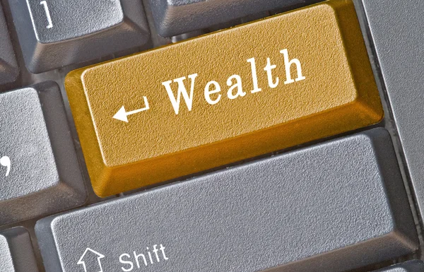 Toetsenbord met sleutel tot rijkdom — Stockfoto