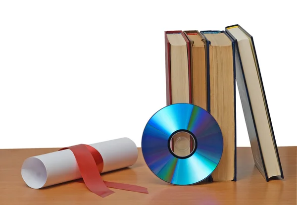 Scroll with red ribbon and books — Stock Photo, Image
