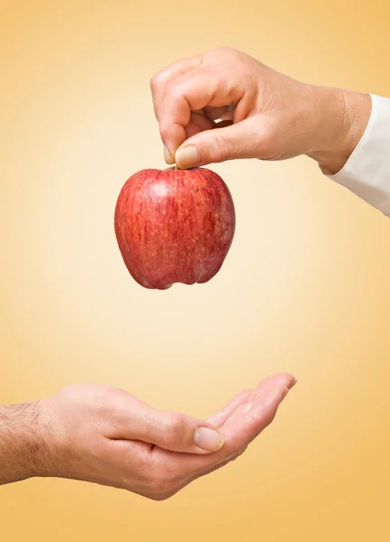 Doctor giving apple as a gift of health — Stock Photo, Image