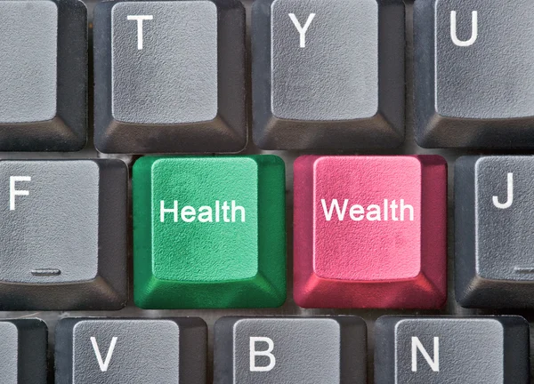 Teclado com chaves para a saúde e riqueza — Fotografia de Stock