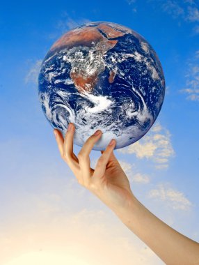 Planet earth in finger.Elements of this image furnished by NASA clipart