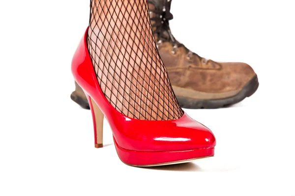Red stilletto shoe with brown walking shoes — Stock Photo, Image