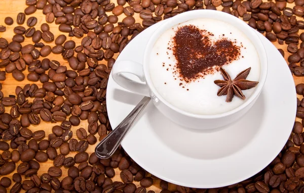 Frothed coffee with heart shape and star aneceed — Stock Photo, Image