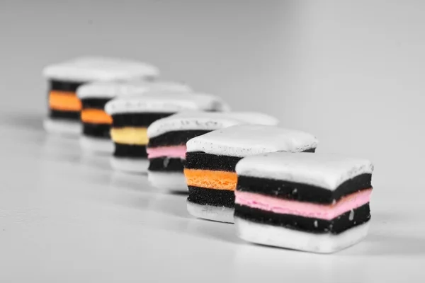 stock image Black and white allsorts with selective color in a row