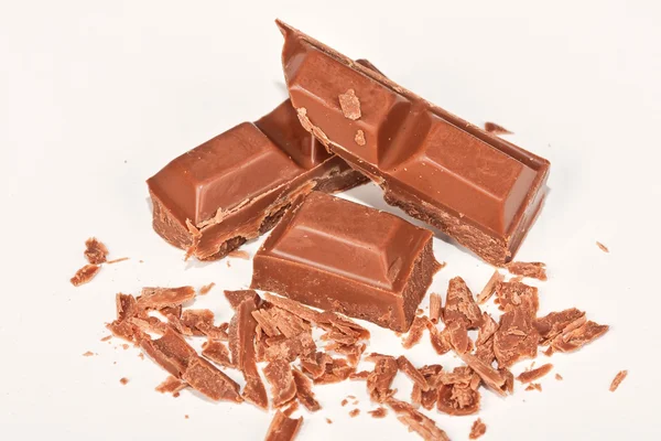 Chocolate blocks lying on a white surface — Stock Photo, Image
