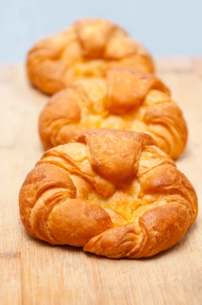 Fresh baked french croissant brioche on wood board — Stock Photo, Image