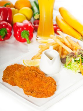 Classic Milanese veal cutlets and vegetables clipart