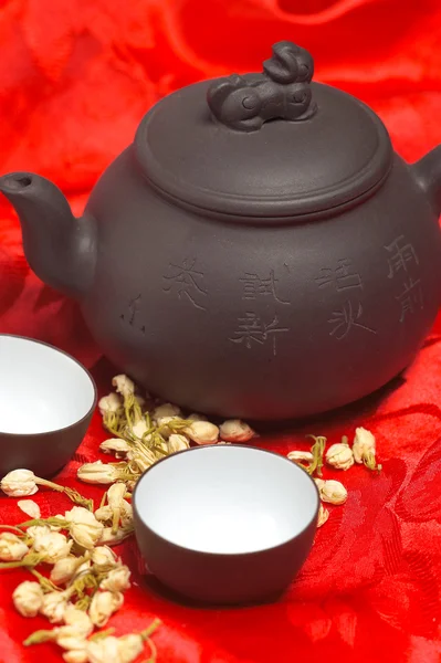 Jasmine tea over red silk — Stock Photo, Image