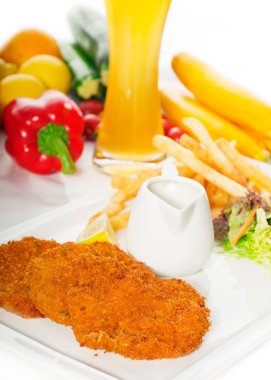 Classic Milanese veal cutlets and vegetables clipart